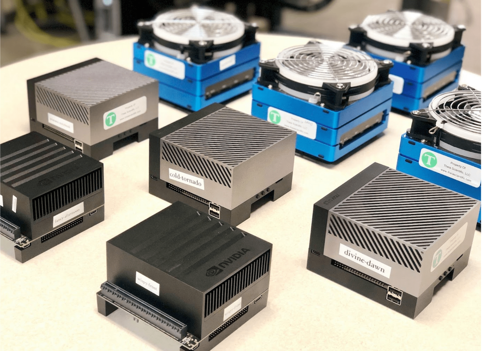 Variety of devices deployed at the University of Michigan - Ann Arbor across three geographical sites creating both local GPU clusters and a campus-wide GPU cluster for real-time electron microscopy image analysis. (Jetson AGX Xavier Devkit, front; Jetson AGX Orin Devkit, middle; Seeed Studio Jetson Mate Advanced with four Jetson Xavier NX modules, back)